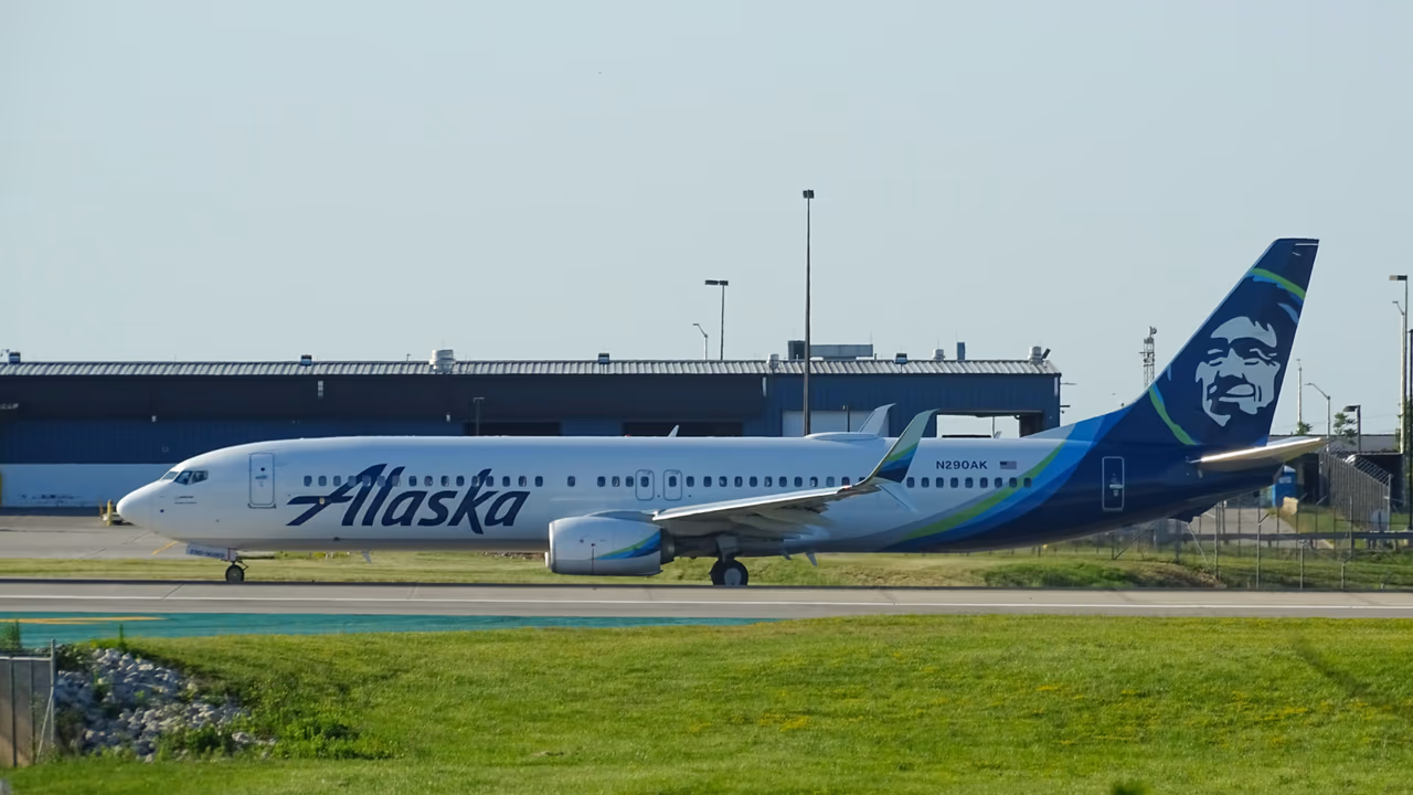 Alaska Airlines aircraft at airport runway.