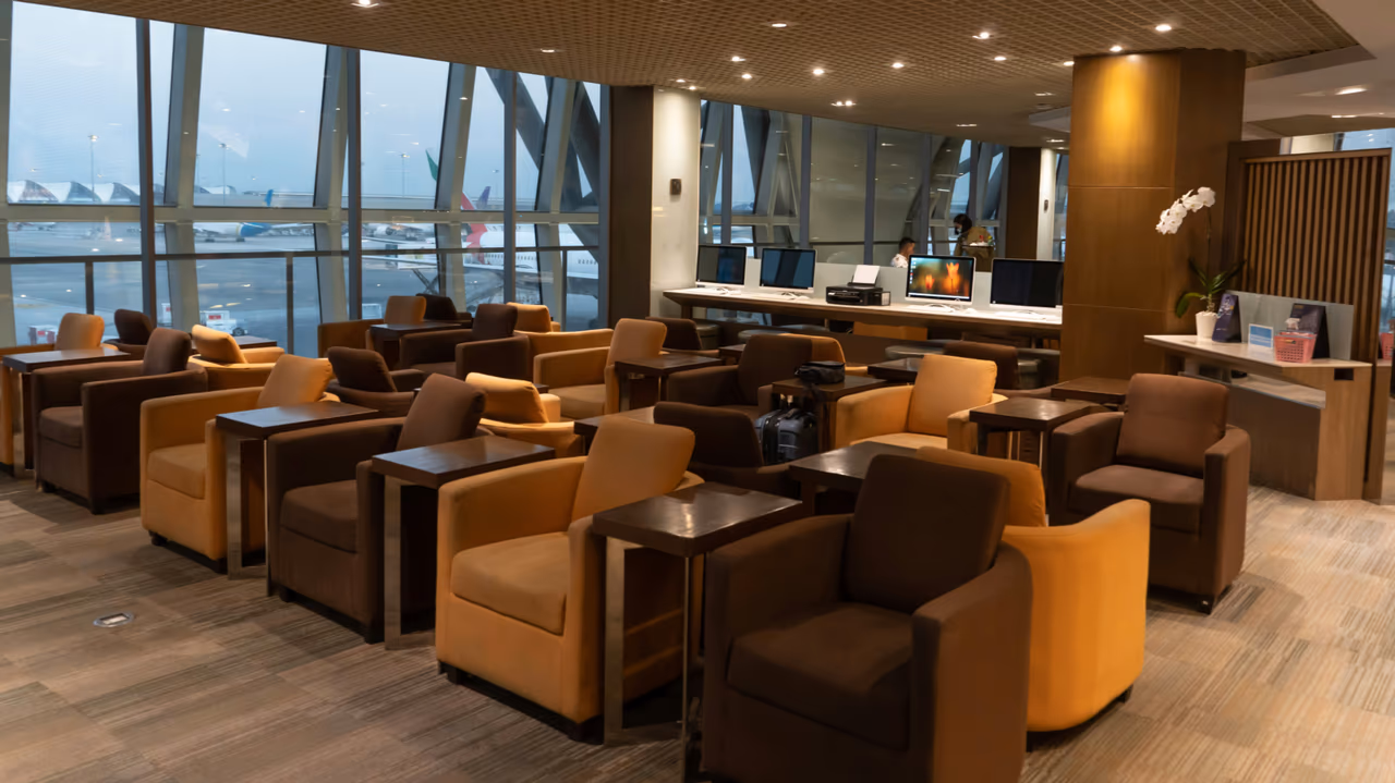 Airport lounge seating area with tarmac views