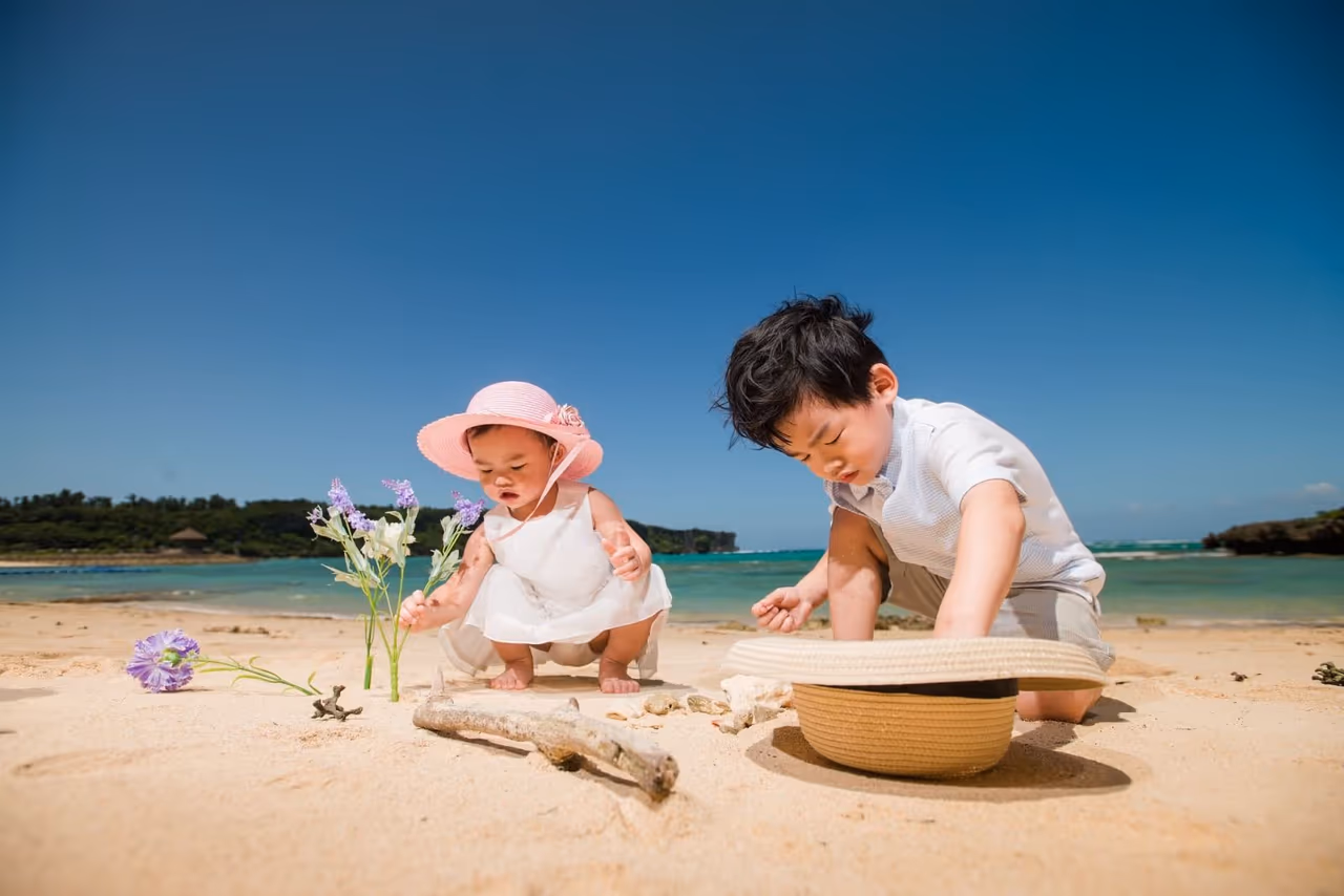 two small children playing on the beach