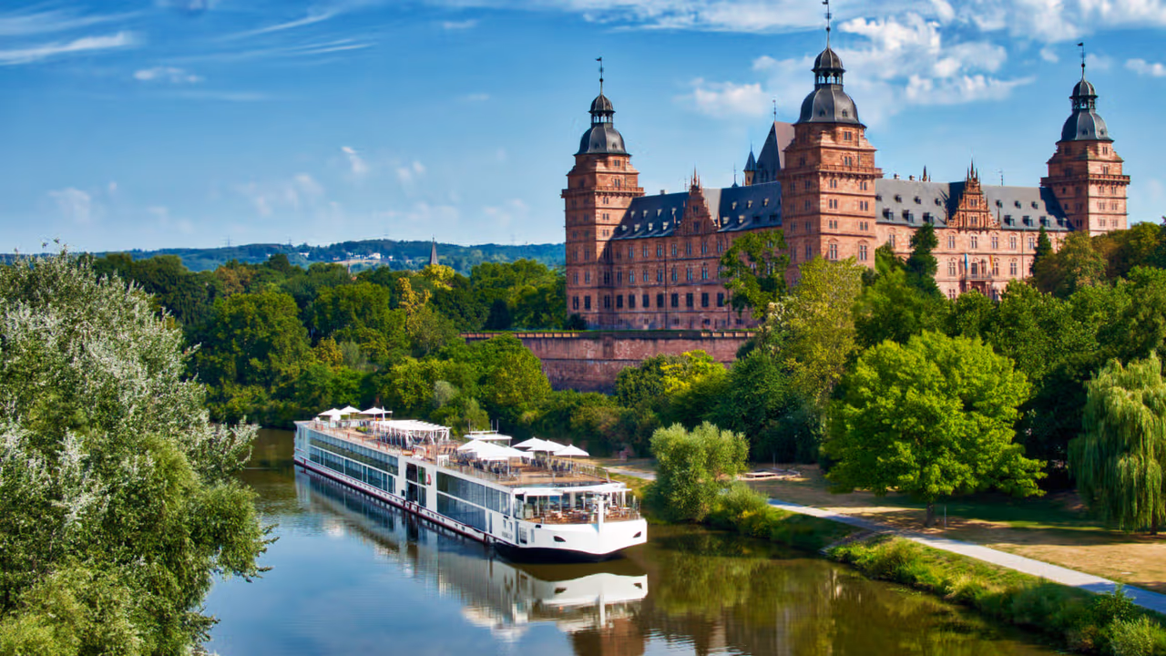 river cruise boat passing a castle
