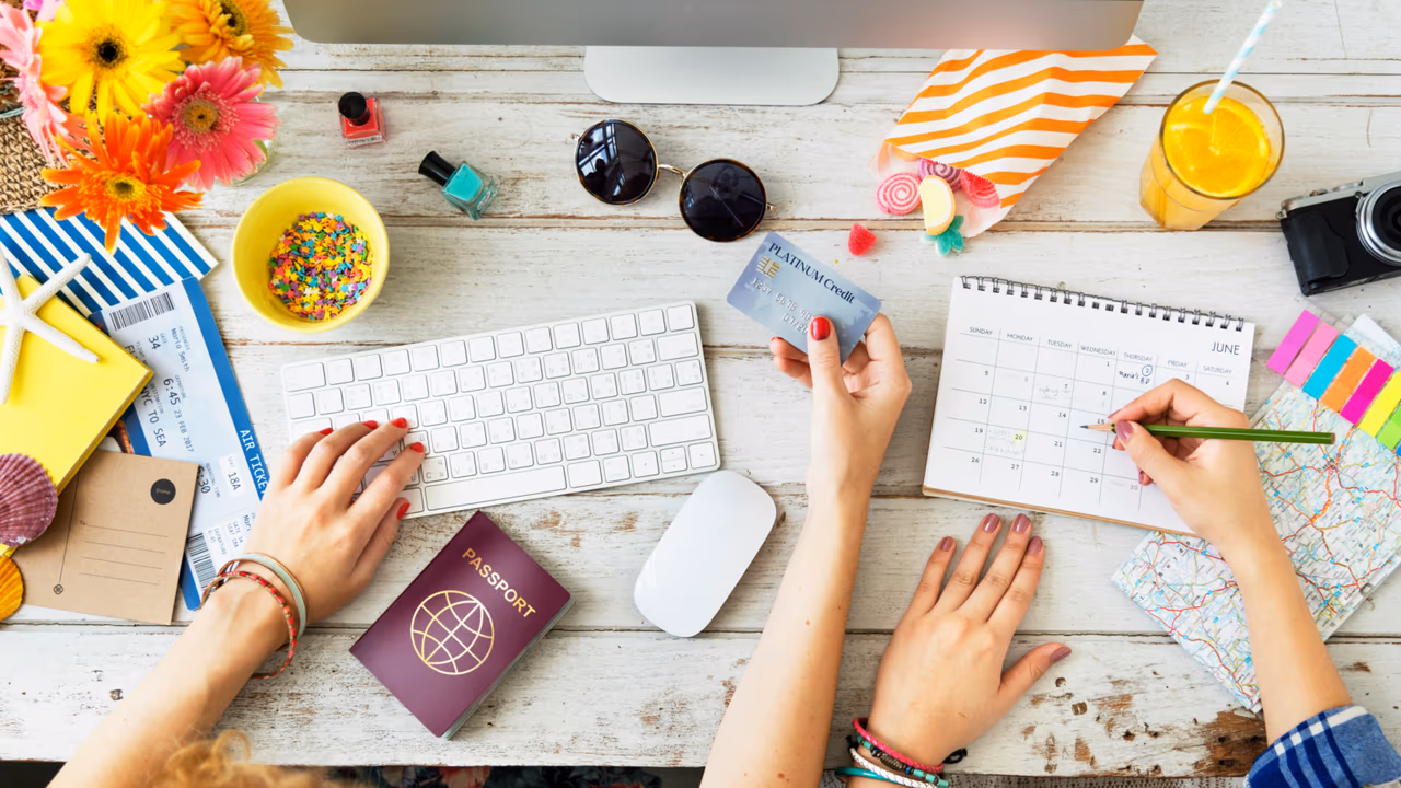 Travel planning with credit card, passport, and calendar.