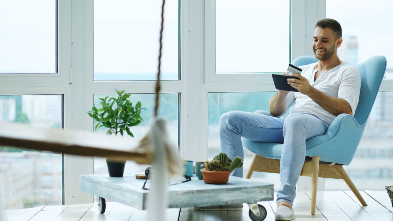 Man paying online with credit card and tablet.