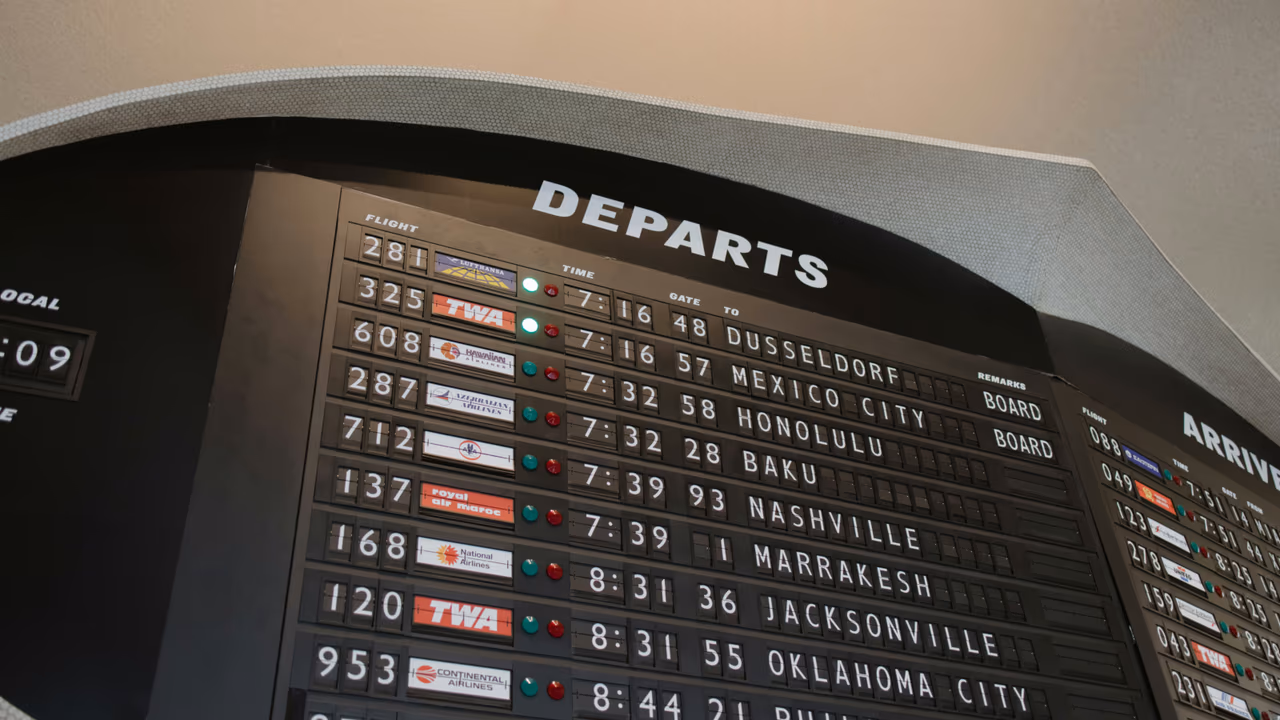 Vintage airport departure board showing flight information and gates