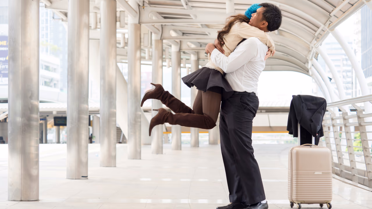 Couple hugging at airport