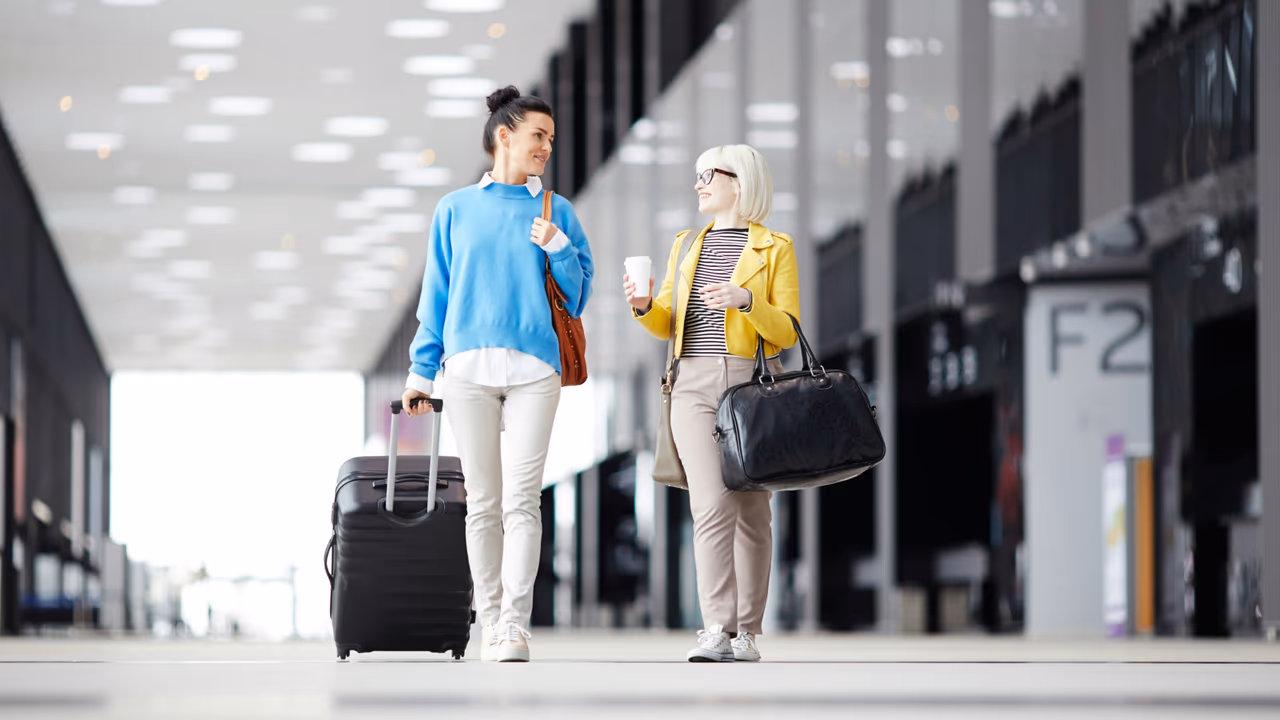 travelers with suitcase and bags in terminal