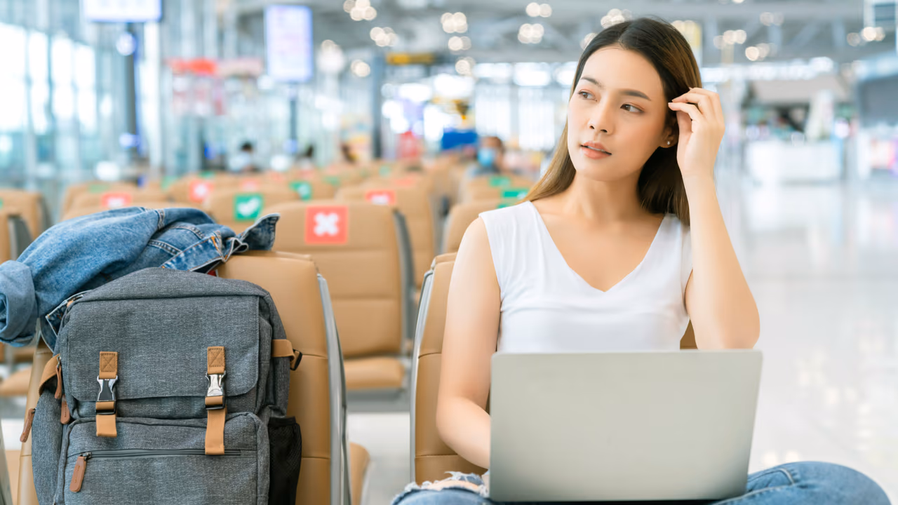 Woman using laptop while waiting at the airport