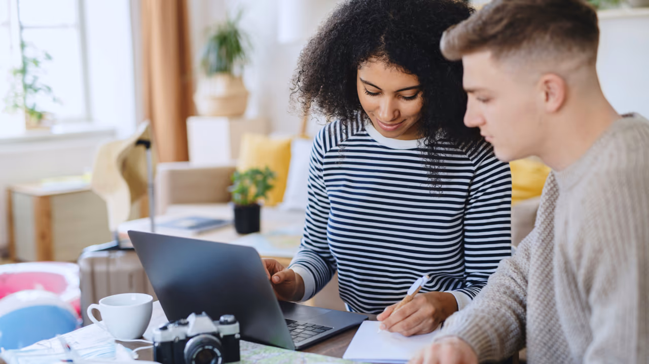 Couple planning travel on a laptop.