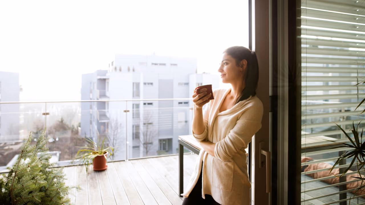 Woman enjoying coffee on balcony