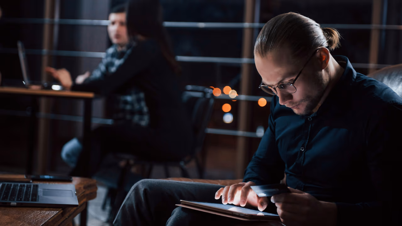 Man reviewing credit card info on tablet