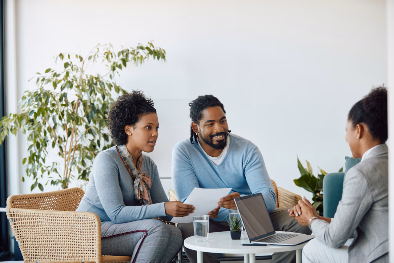 people sitting around a table talking about their personal loan