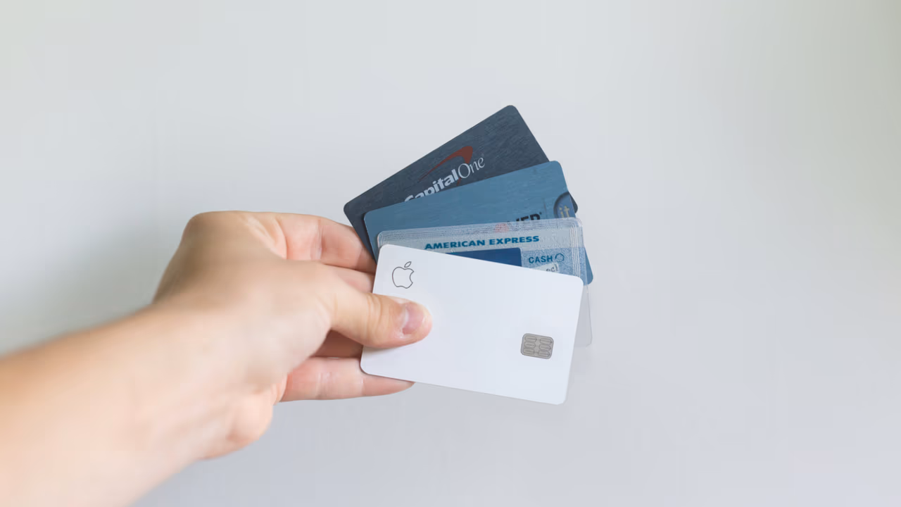 Person holding multiple credit cards