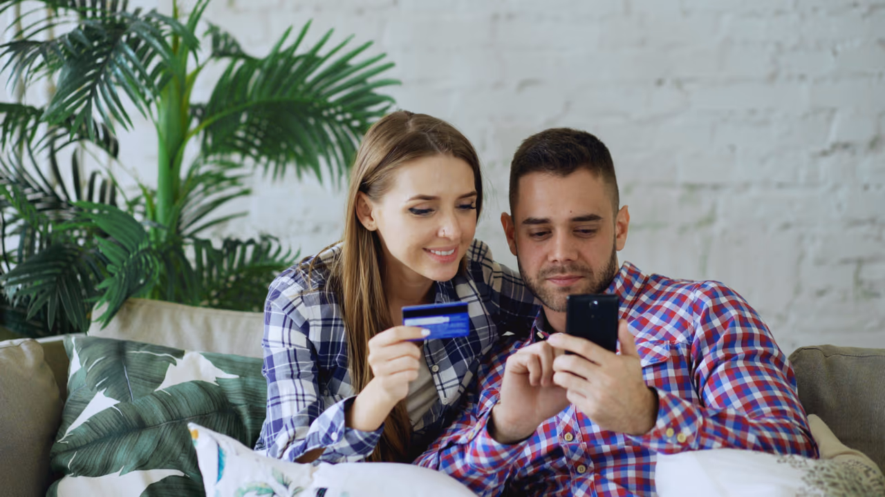 Couple using credit card for online purchase