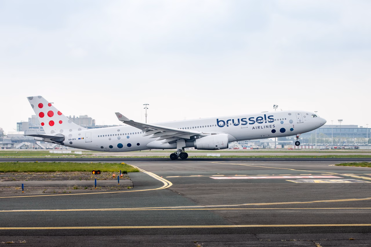 A Brussels Airlines Airbus A330 with a red-dotted tail lifting off the runway on an overcast day