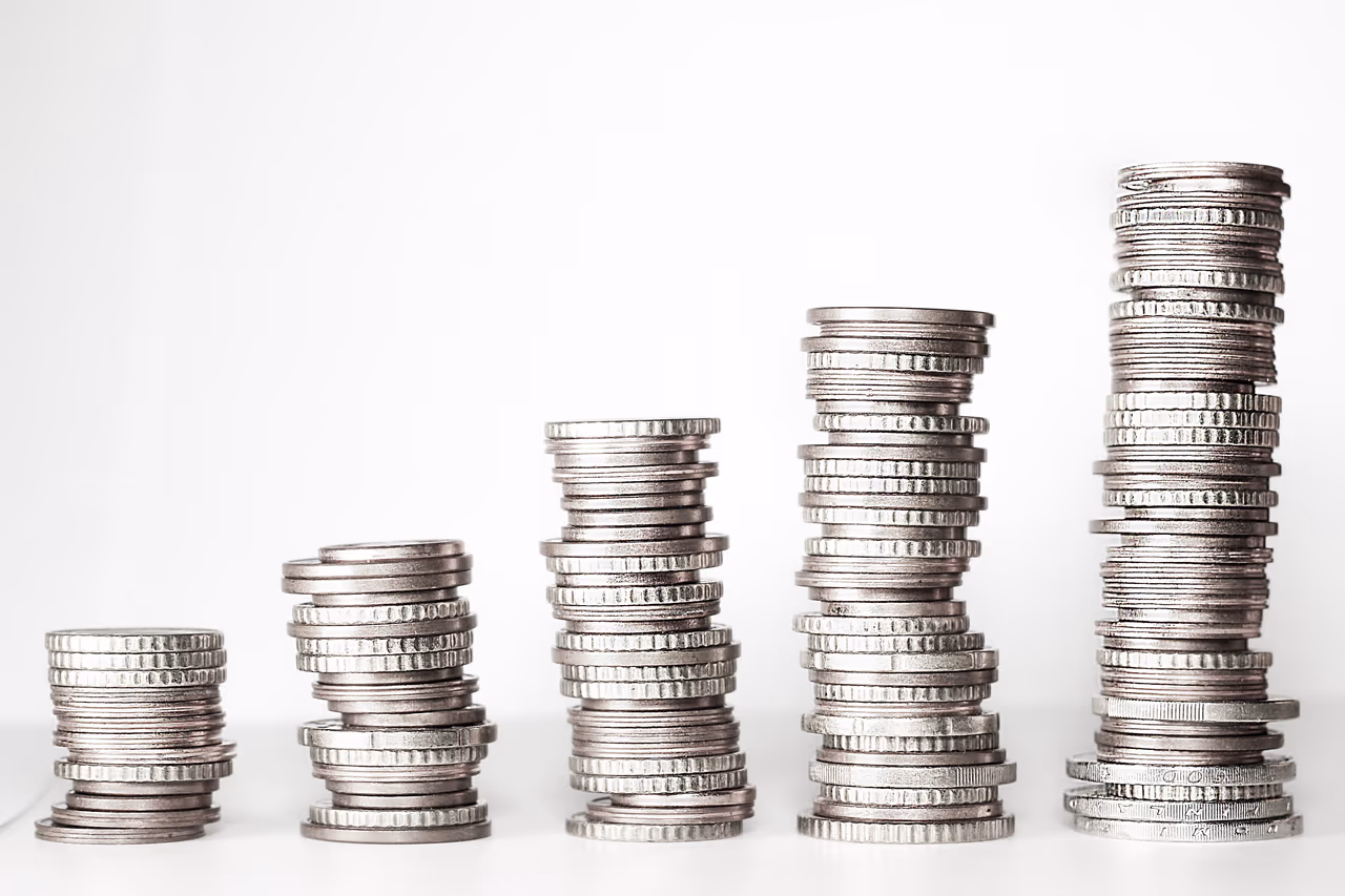Stacks of coins of varying heights on a flat surface