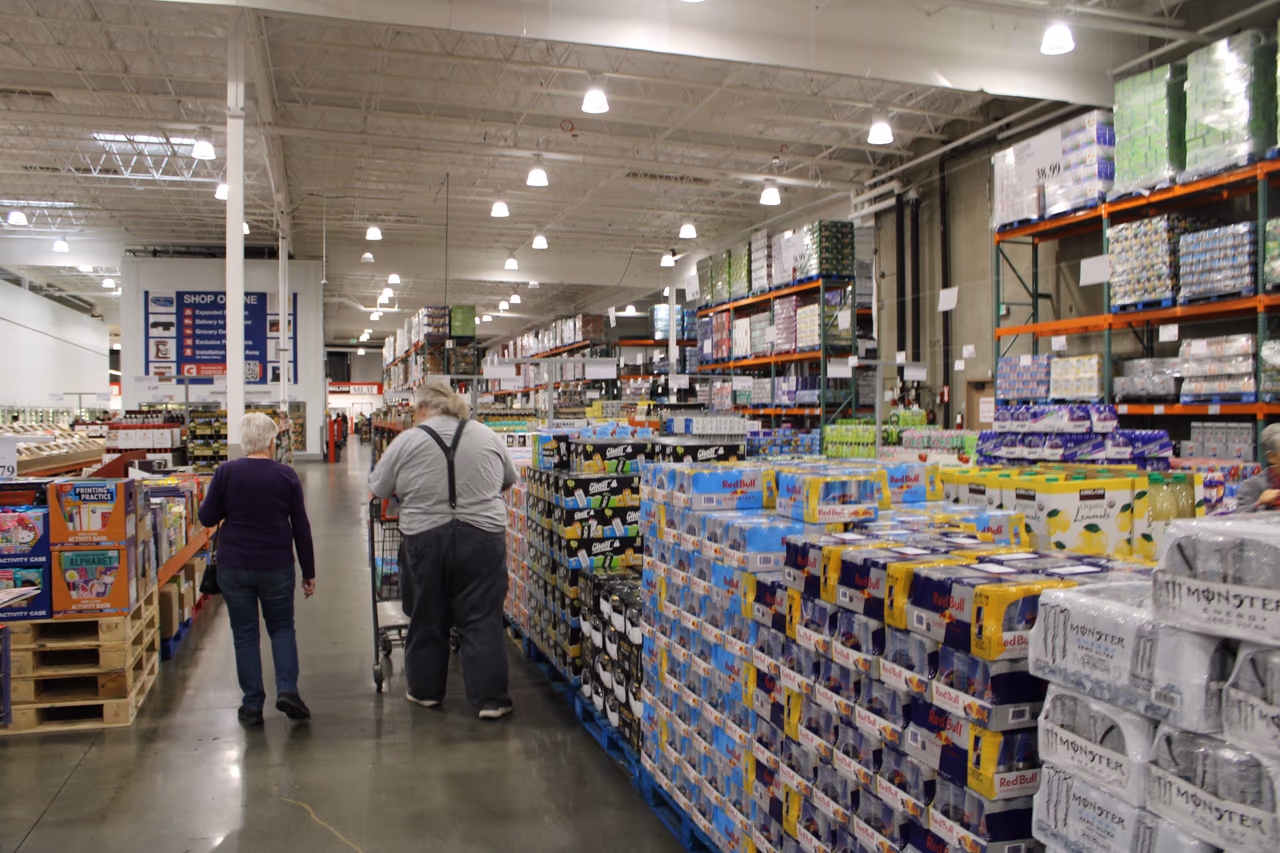 The exterior of a Costco warehouse store with parked cars in front