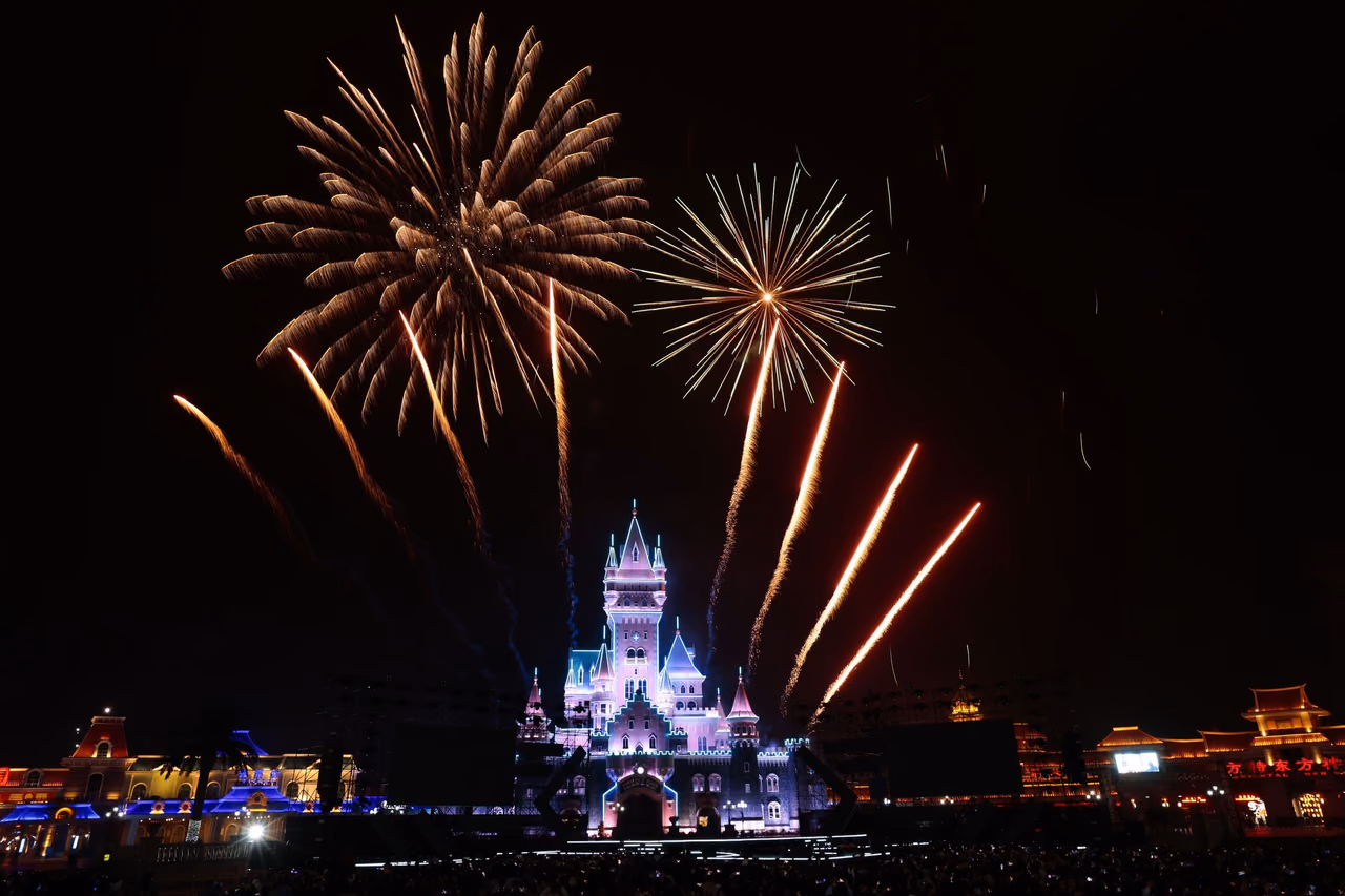Fireworks bursting in the night sky over a fairy-tale castle at a Florida theme park resort