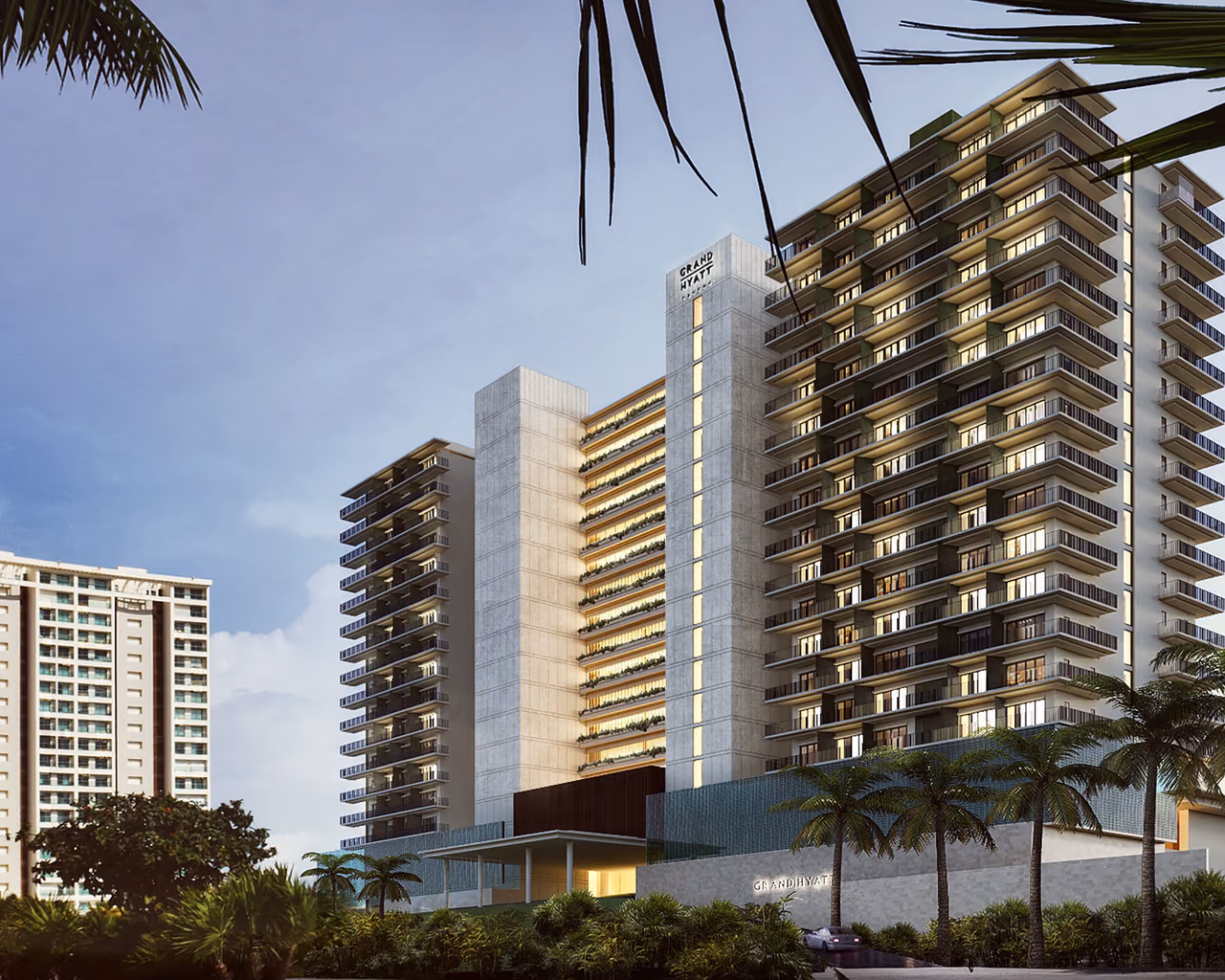 Guest room towers and entrance signage at Grand Hyatt Cancun Beach Resort, seen from the street at dawn