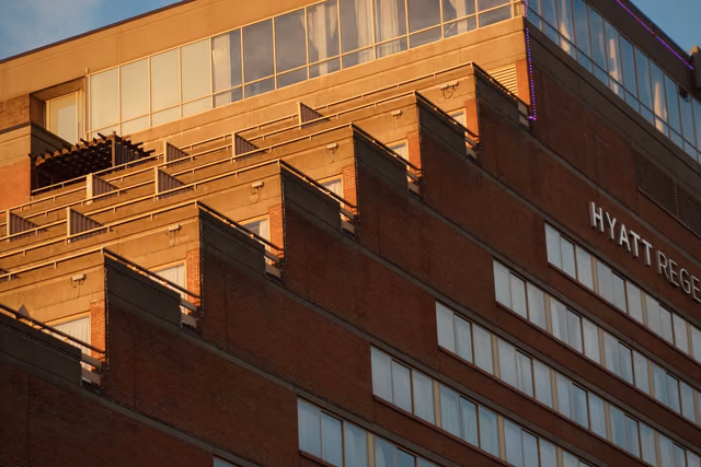 Hyatt Regency hotel facade lit by warm sunset light