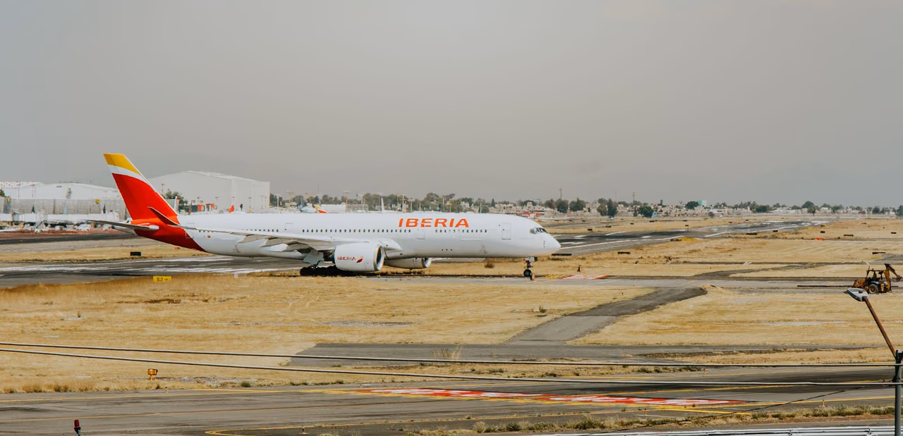 An Iberia airplane on the runway at an airport