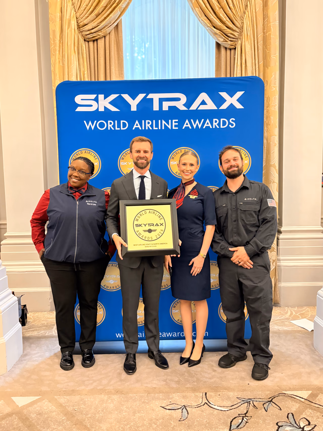 Delta employee portraits featured in the airline's Times Square display marking its fifth Skytrax staff service award
