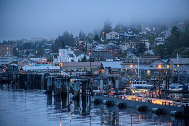 Foggy morning over the Ketchikan, Alaska harbor with the waterfront town reflected in the water
