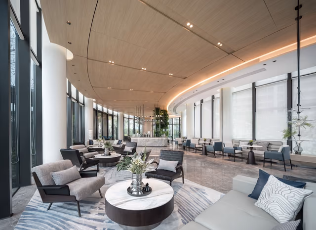 A spacious luxury hotel lobby with modern design and elegant furnishings