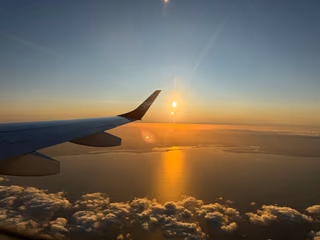 Ocean at sunset seen from an airplane window