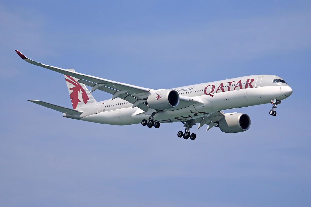 Qatar Airways Airbus A350 flying through a clear blue sky