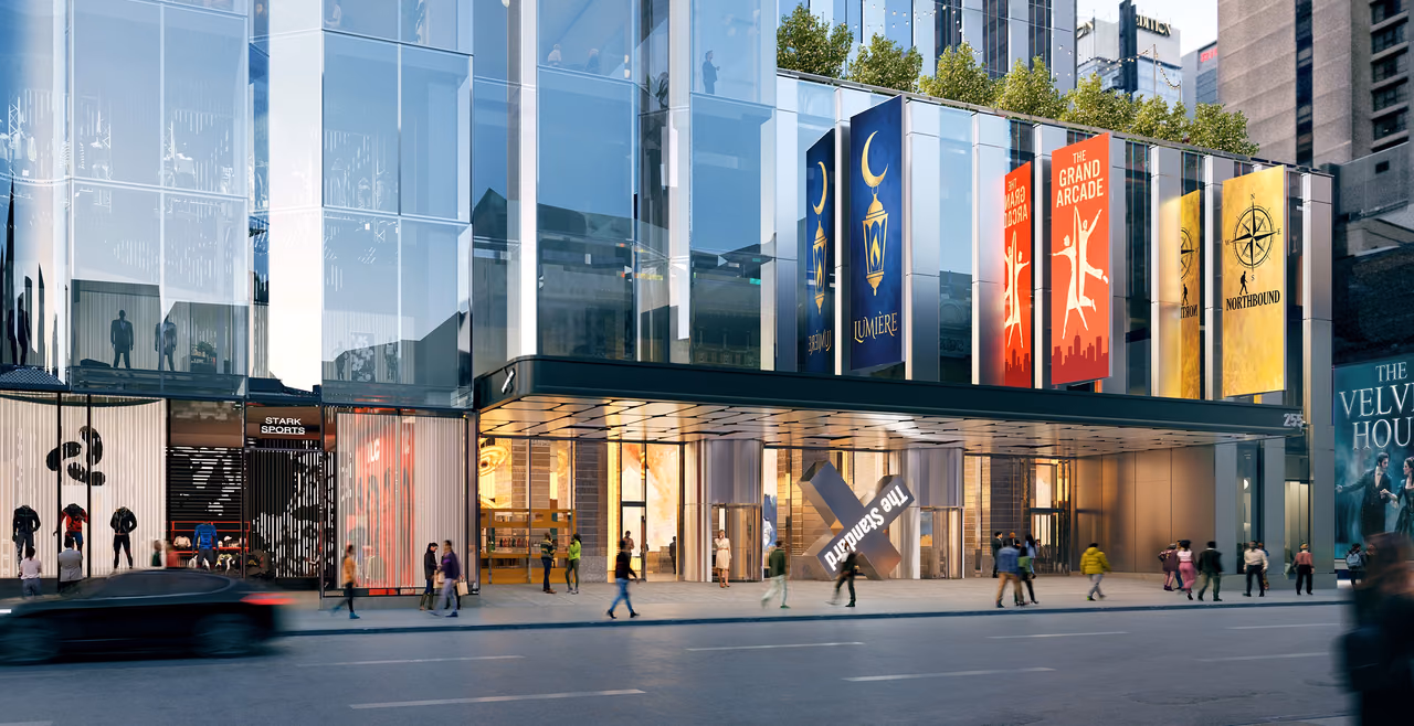 Rendering of The StandardX Times Square at street level, with a glass facade, hanging banners and an X sign over the entrance