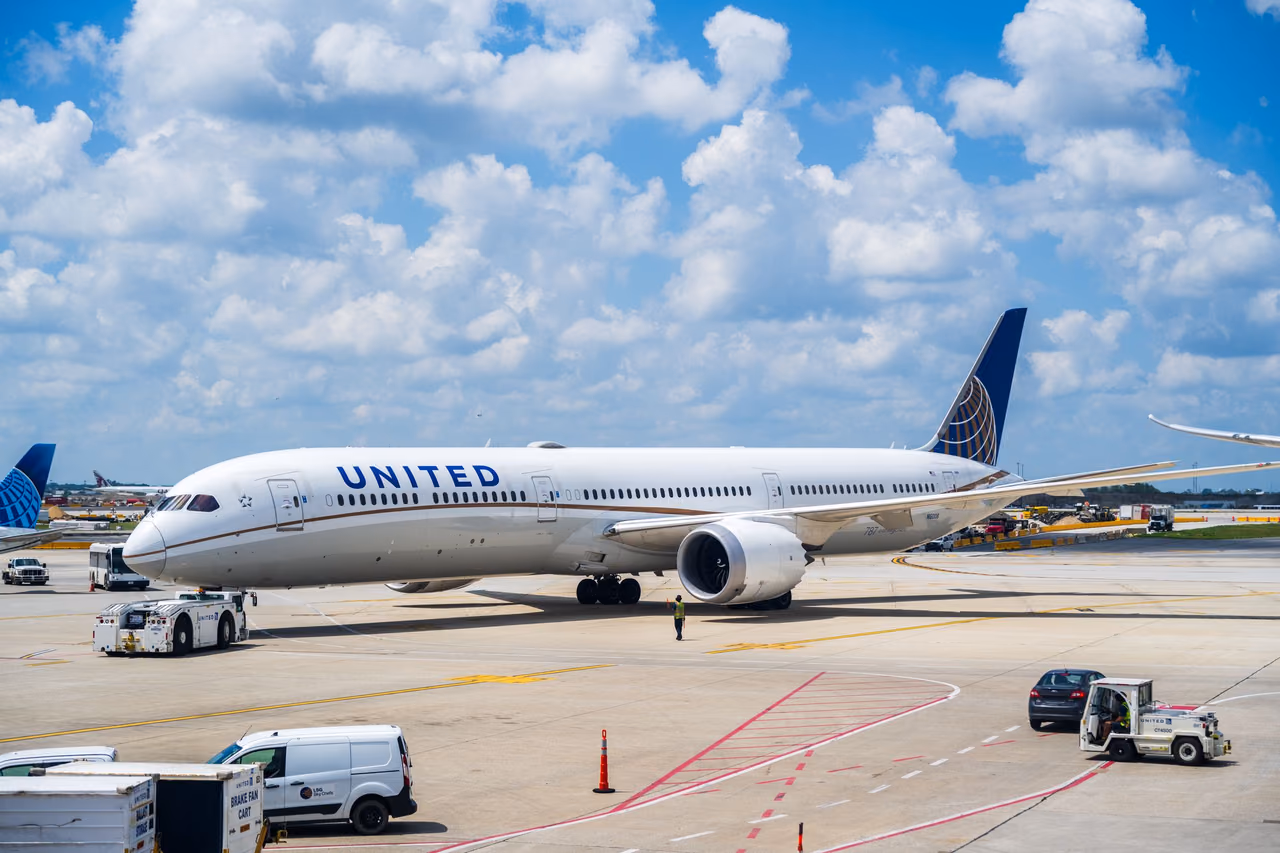 United Airlines Boeing 787 Dreamliner on the airport apron under a blue sky with scattered clouds
